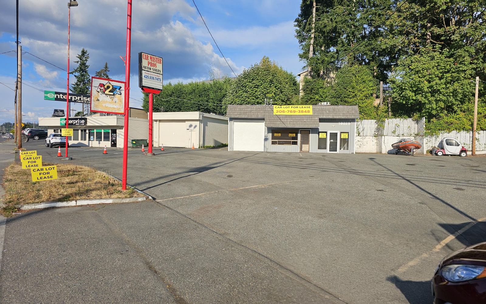 Street view of the car lot and building on Hwy 99 Auto Row with neighboring dealerships