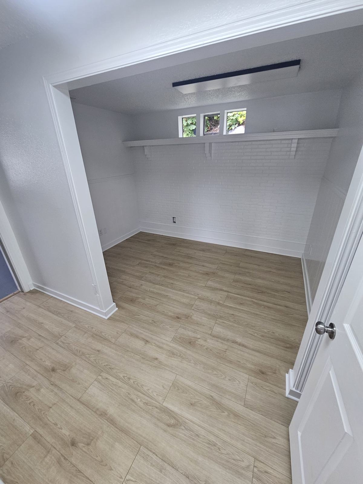 Second office with painted brick wall and new flooring