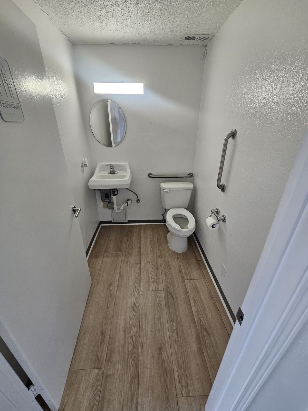 Remodeled restroom with grab bars